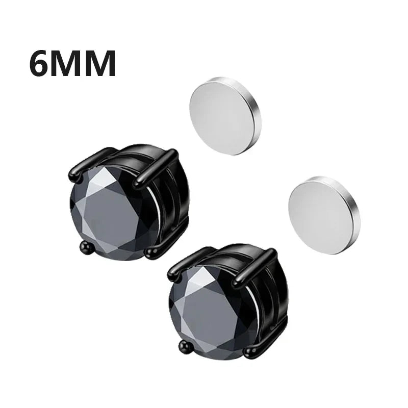 Black stud earrings with clear gemstones and two silver discs on a white background.