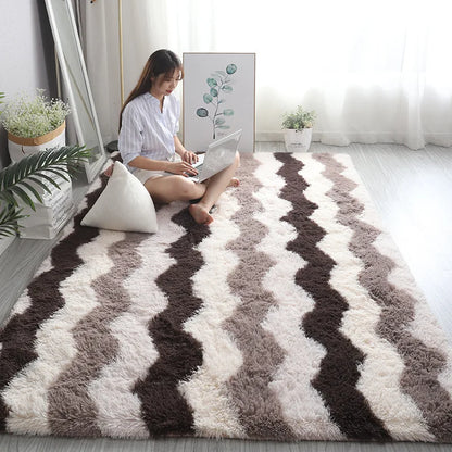 Woman sitting on a patterned rug in a bright room with plants and a mirror.