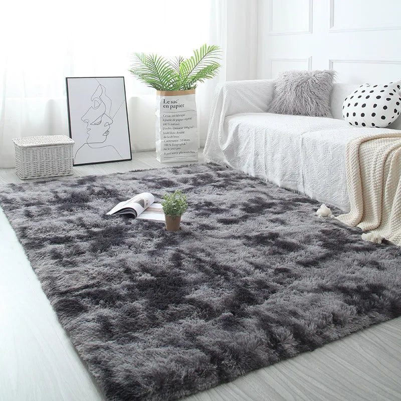 Gray shaggy rug in a living room with a white sofa, books, and a plant.