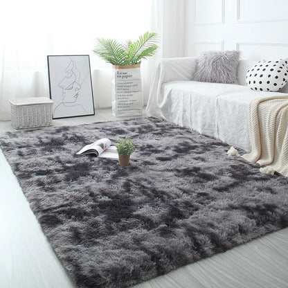 Gray shaggy rug in a living room with a white sofa, books, and a plant.