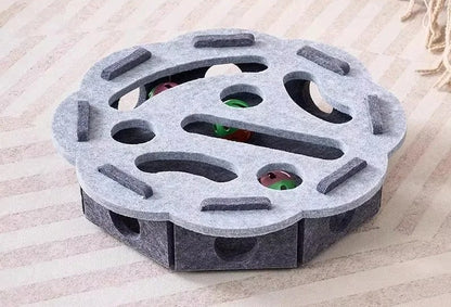 Hexagonal gray object with circular cutouts on a wooden surface