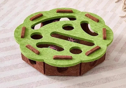 Green and brown puzzle toy for pets on a textured surface