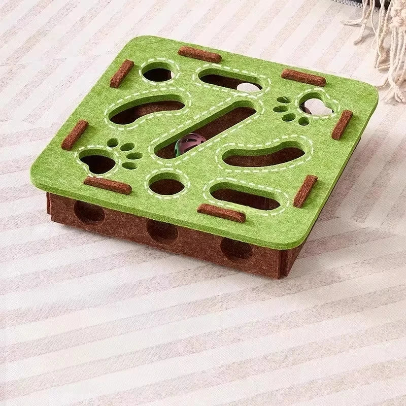 Green and brown puzzle toy for small animals on a white background