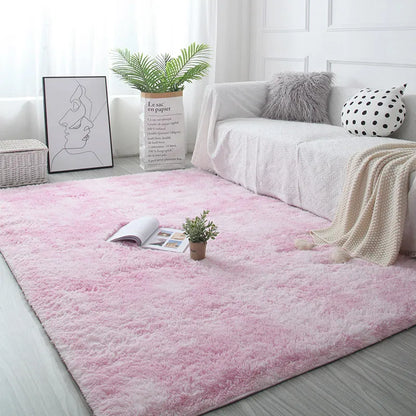 Living room with a pink rug, white sofa, and decorative items.
