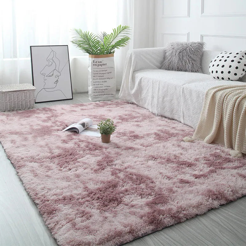 Living room with a pink rug, white sofa, and decorative items.
