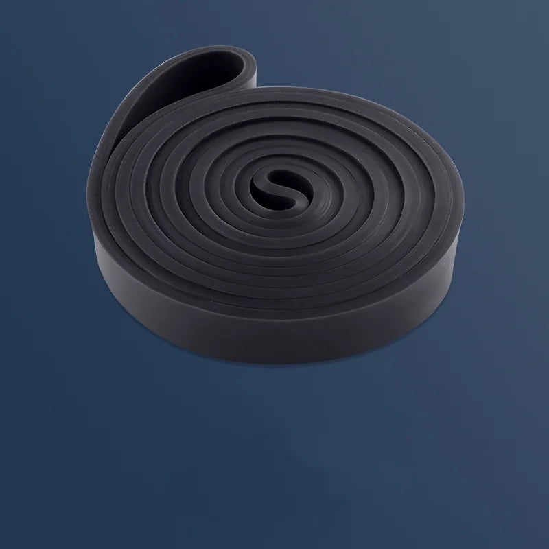 Coiled black rubber band on a dark blue background