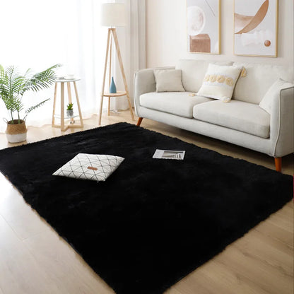Black rug on a wooden floor in a living room with a white sofa and decor.