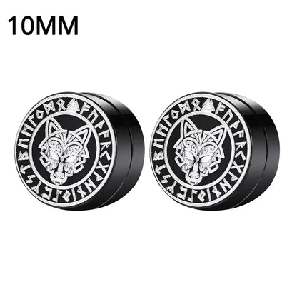 Pair of black and silver earrings with wolf design and runes on a white background.