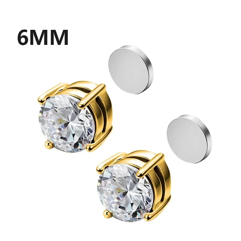 Gold stud earrings with clear gemstones and two round metal discs on a white background.